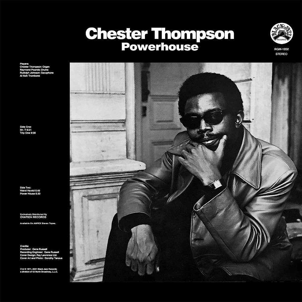 Limited edition clear vinyl album cover for "Powerhouse" by Chester Thompson, released by Tandem Coffee Roasters. The black and white image features Chester in a leather jacket, sunglasses, and watch, casually seated in front of a building. Album details and tracklist are subtly arranged around the picture.