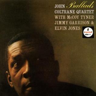 The album cover for John Coltrane's "Ballads" from Tandem Coffee Roasters features a close-up of Coltrane's face against a shadowed background. In the top right corner, text lists the musicians: the Coltrane Quartet, McCoy Tyner, Jimmy Garrison, and Elvin Jones. The serene backdrop complements tracks like "Say It (Over," with the Impulse! label logo displayed prominently.