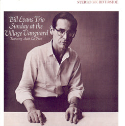 Album cover featuring a sepia-toned photo of a man with glasses, seated and looking towards the camera. Text reads, "Bill Evans Trio - Sunday At the Village Vanguard, Featuring Scott La Faro." The Riverside label is in the top corner. Includes tracks like "Gloria's Step" and "Jade Visions." Brought to you by Tandem Coffee Roasters.