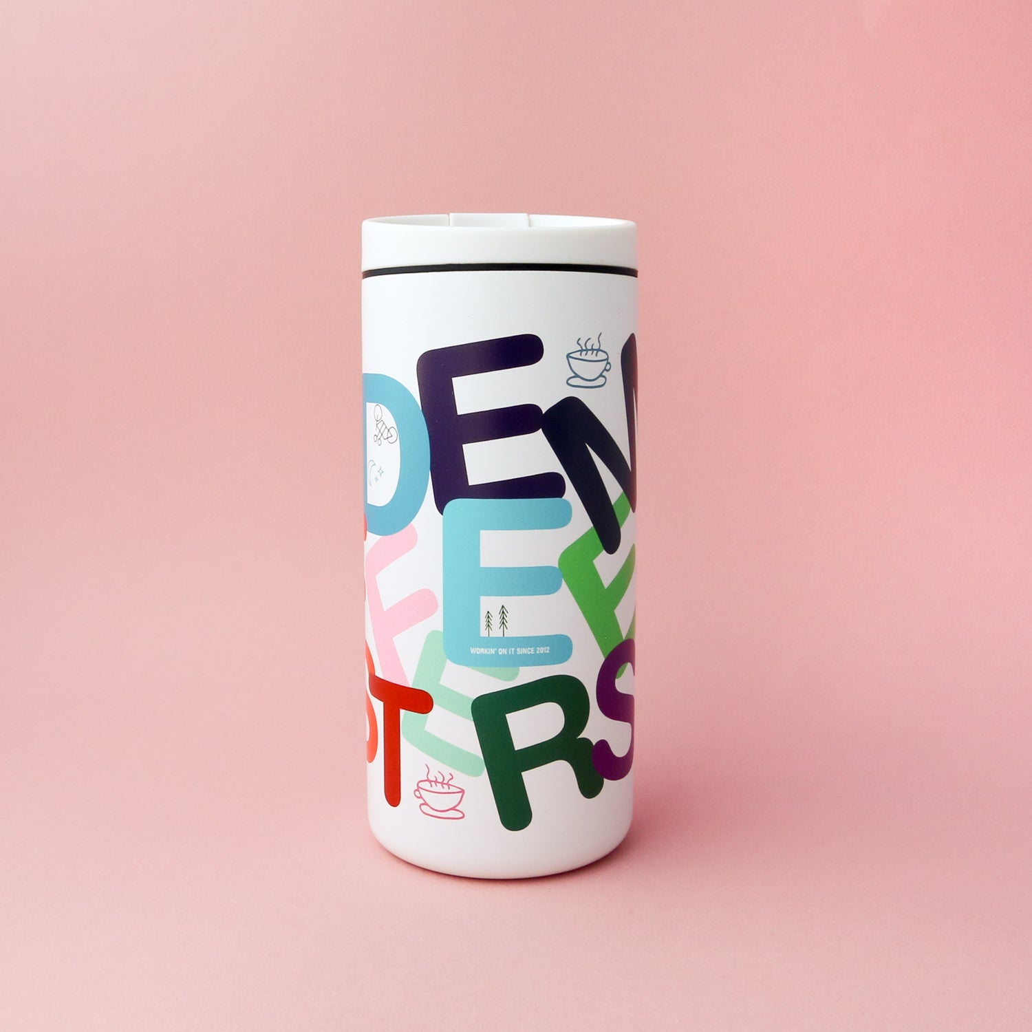 A white thermal travel mug with double-wall vacuum insulation, colorful overlapping letters reading "OPEN FEEL EATERS" on a pink background. The Letter Mug by Tandem Coffee Roasters also features small icons of steaming coffee cups, minimalist designs of people, and a leak-proof lid.