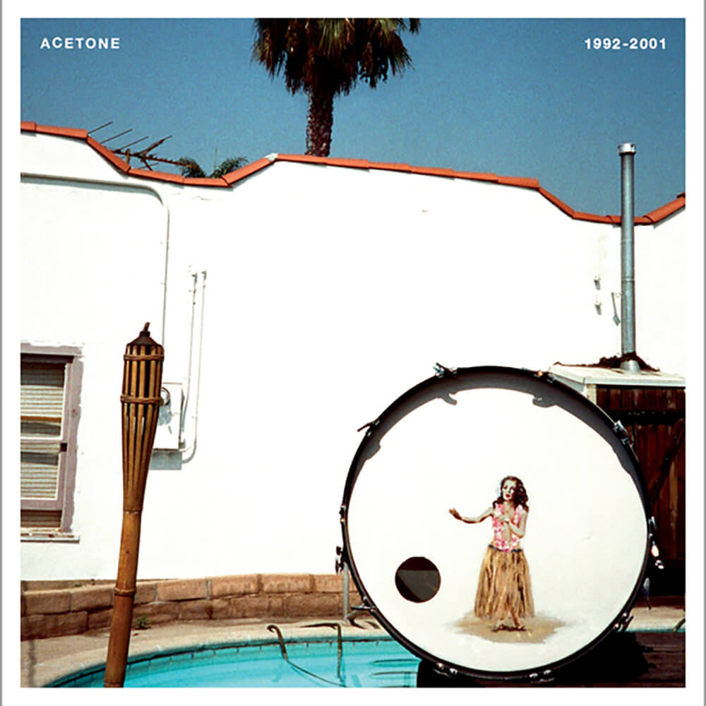 Album cover featuring a large bass drum with a woman's image on it, placed beside a swimming pool with a white building and palm tree in the background. Text "Acetone - 1992-2001 (Limited Edition Double Color LP)" by Tandem Coffee Roasters.