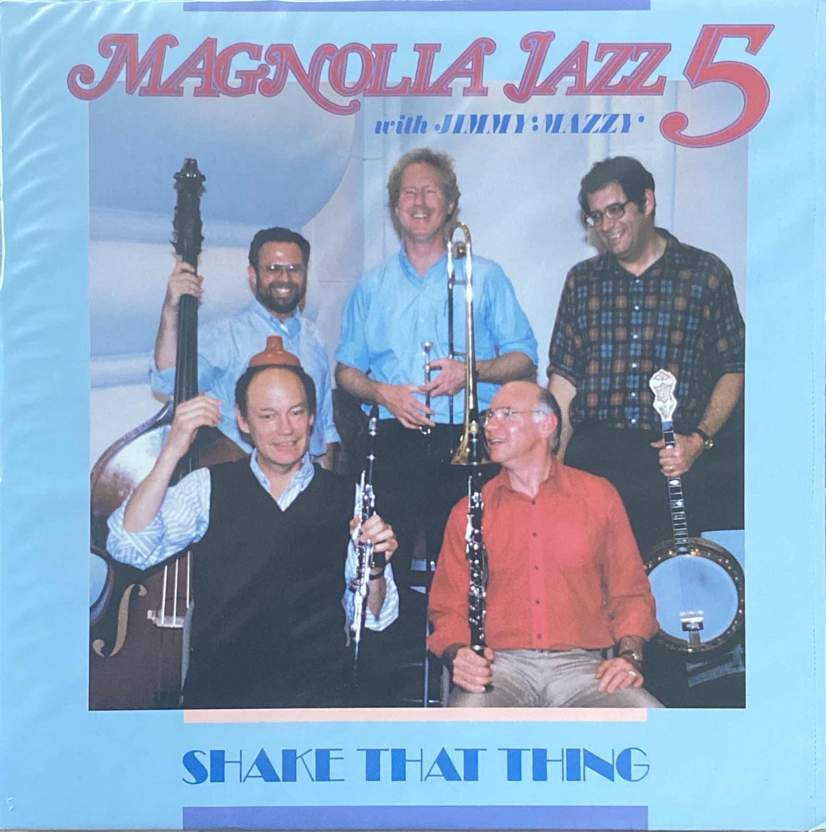 Album cover for "Jimmy Mazzy and Magnolia Jazz 5- Shake That Thing" by Tandem Coffee Roasters featuring five male musicians with various instruments like a banjo-playing and clarinets, smiling against.