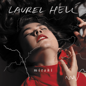 Album cover of "Laurel Hell" by Mitski, showing a close-up of her with eyes closed, head back, in a red outfit. Her hair fans out, and white lines on Tandem Coffee Roasters packaging.