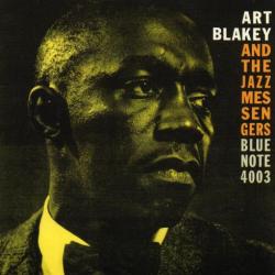 A close-up of Art Blakey in yellow-toned lighting adorns the album cover for "Art Blakey and the Jazz Messengers - Moanin'." The text on the right side reads "Art Blakey and the Jazz Messengers Blue Note 4003" in a mix of white, orange, and yellow fonts, featuring tracks like "Moanin'" and "Blues March," by Tandem Coffee Roasters.