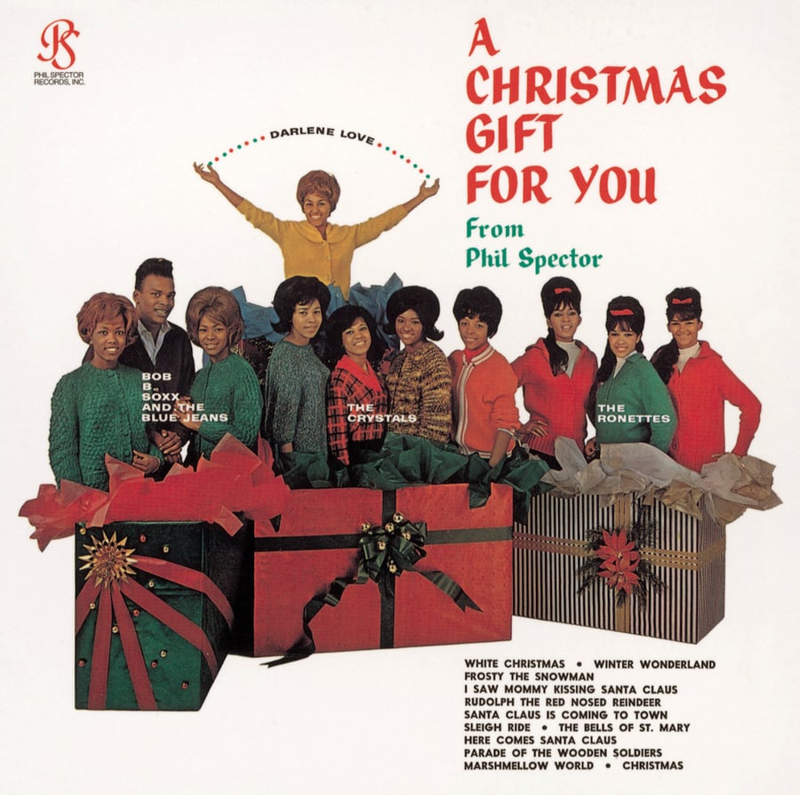 Album cover of "Tandem Coffee Roasters - A Christmas Gift for You" featuring Darlene Love and multiple artists in festive attire grouped around large gift boxes, with a song list and artist names included.