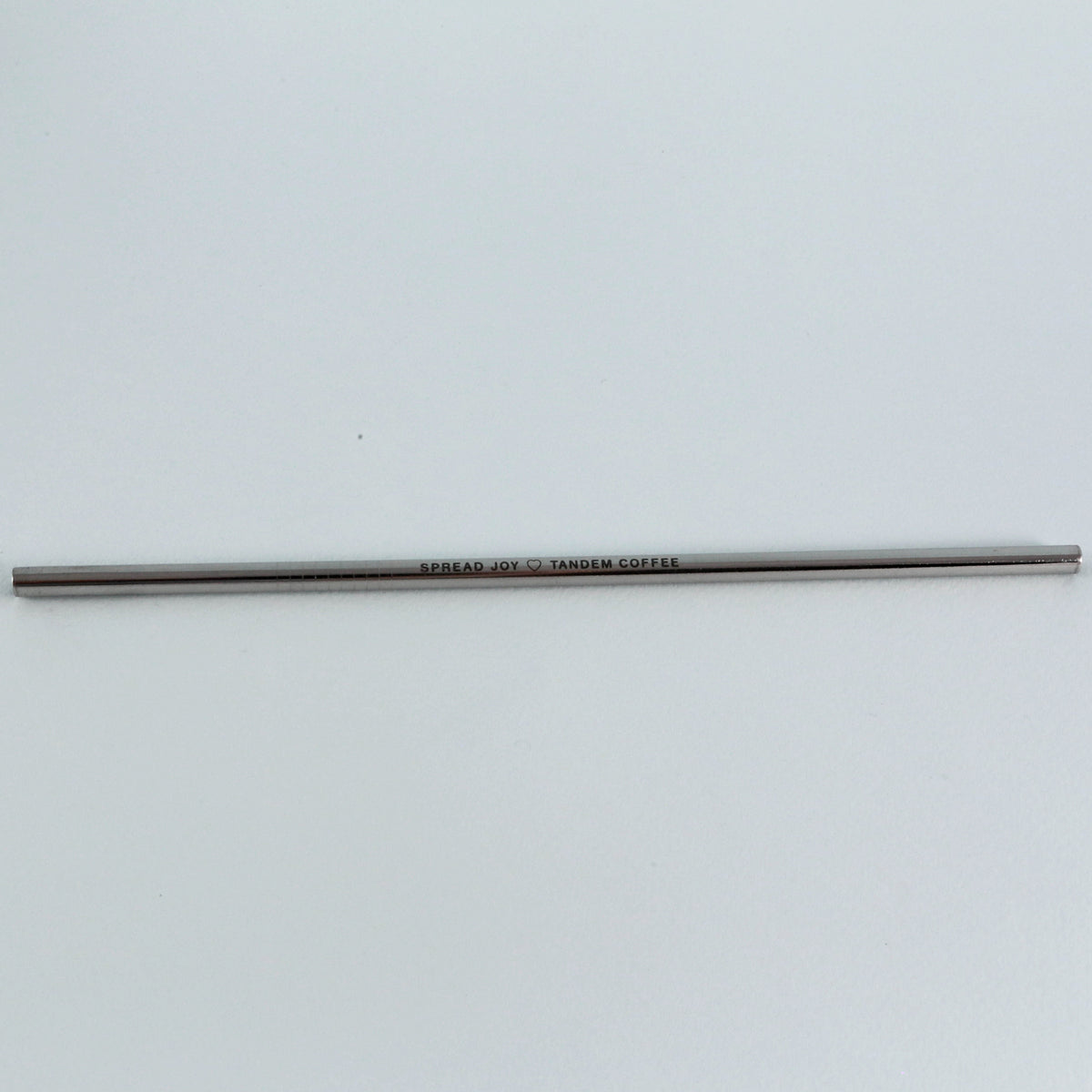 A slender, gray pencil with the inscription "Tandem Coffee Roasters Tandem Straw" centered along its side, set against a plain white background.